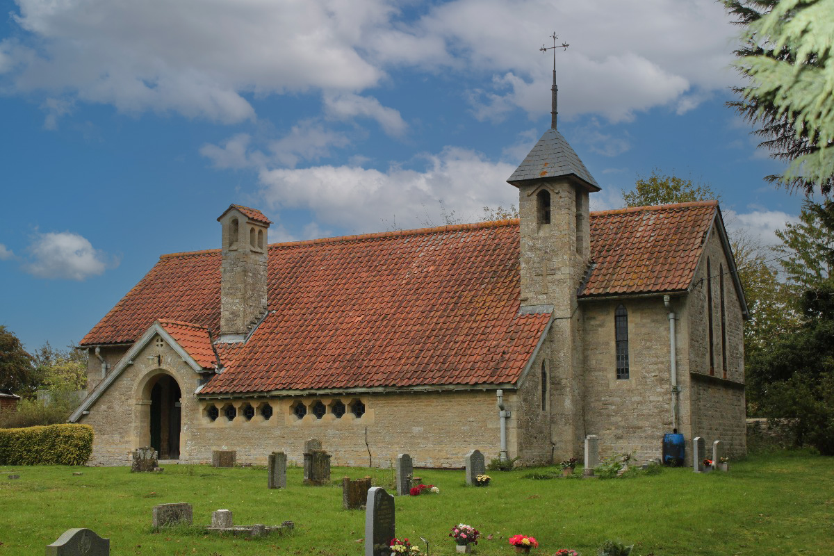 St John the Baptist Church, Curbridge, under a blue sky